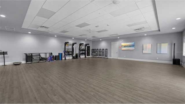 miscellaneous room featuring wood finished floors, baseboards, visible vents, a tray ceiling, and recessed lighting