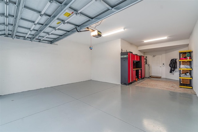 garage featuring a garage door opener and water heater