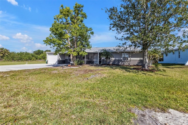 single story home with concrete driveway, an attached garage, and a front lawn