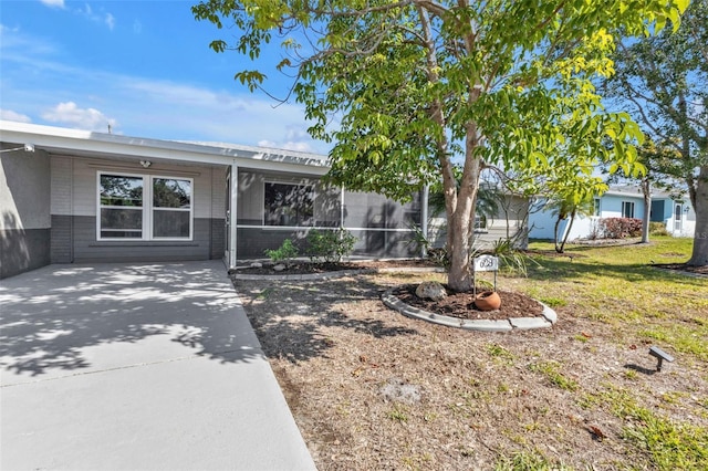 ranch-style home with brick siding and a front lawn