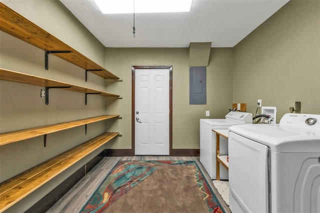 washroom with laundry area, electric panel, baseboards, and washing machine and clothes dryer