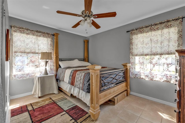 bedroom with multiple windows, tile patterned flooring, and baseboards