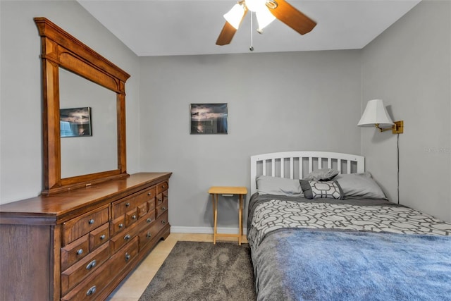bedroom with light tile patterned floors, baseboards, and a ceiling fan