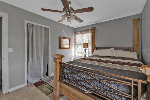 tiled bedroom with a ceiling fan and baseboards