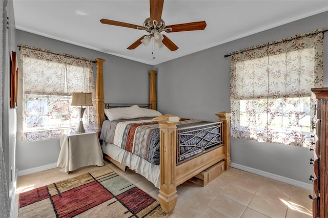 bedroom with a ceiling fan, baseboards, and tile patterned flooring