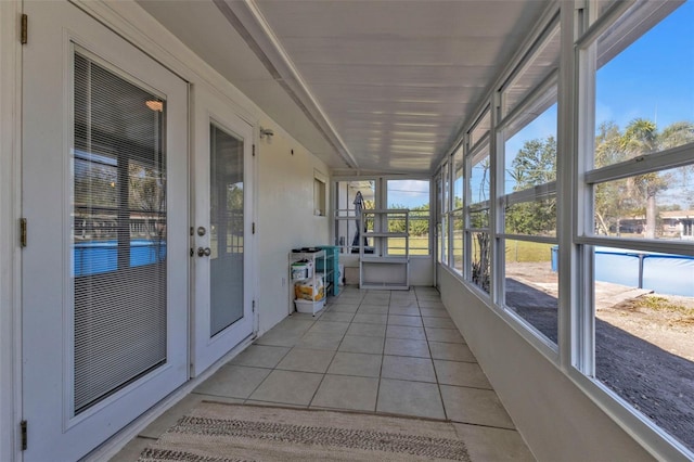 unfurnished sunroom featuring french doors