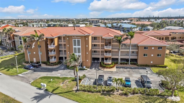 view of building exterior featuring uncovered parking and a residential view