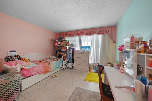 bedroom with a textured ceiling and light tile patterned flooring