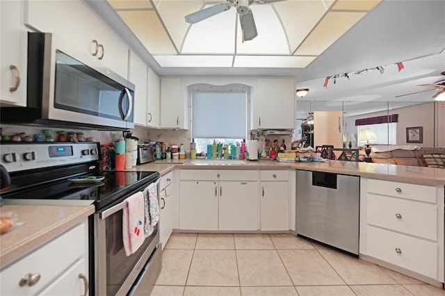 kitchen with ceiling fan, light countertops, appliances with stainless steel finishes, and light tile patterned floors