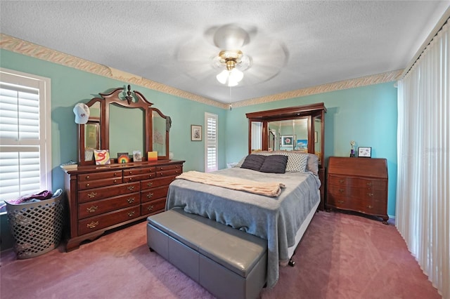 carpeted bedroom featuring a ceiling fan and a textured ceiling