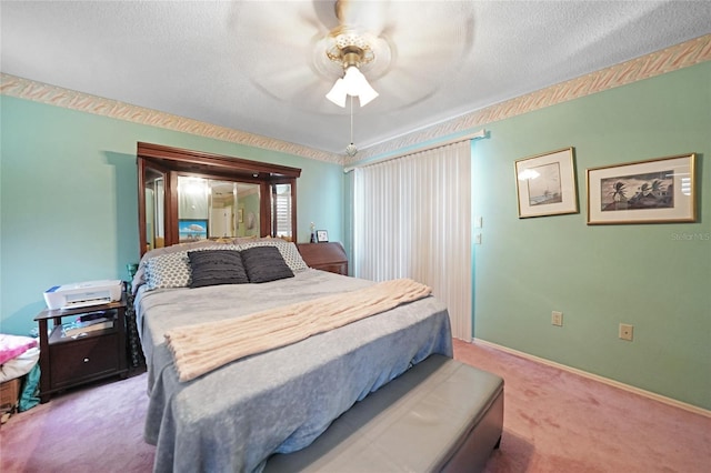 bedroom with light carpet, baseboards, and a textured ceiling