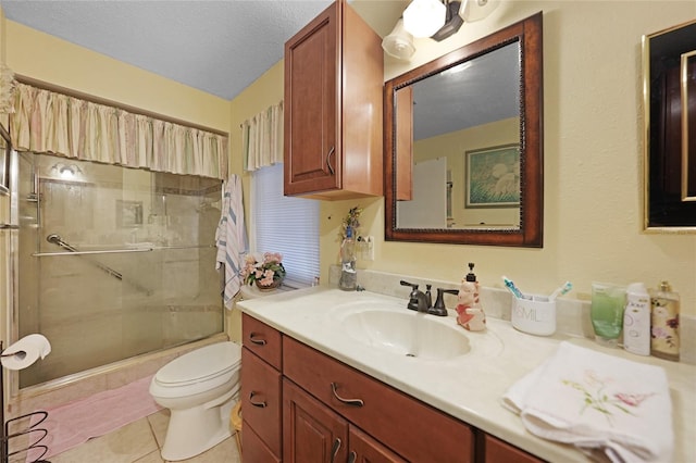 full bathroom with toilet, an enclosed shower, a textured ceiling, vanity, and tile patterned flooring