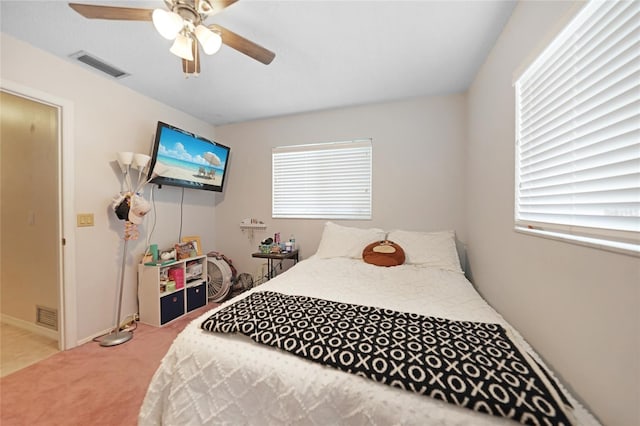 carpeted bedroom featuring ceiling fan and visible vents