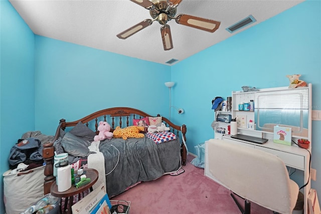 carpeted bedroom with lofted ceiling, a textured ceiling, visible vents, and a ceiling fan