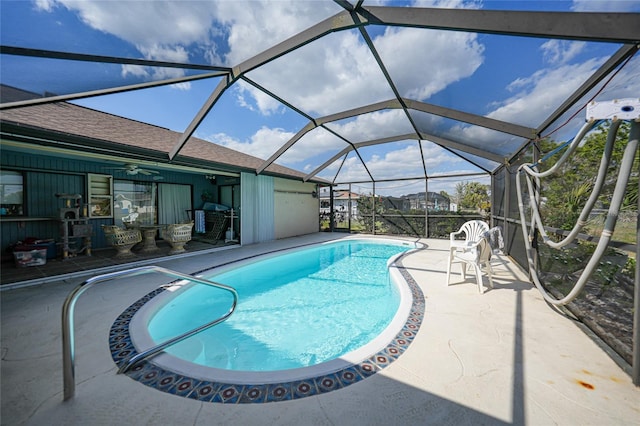 outdoor pool with a lanai and a patio area