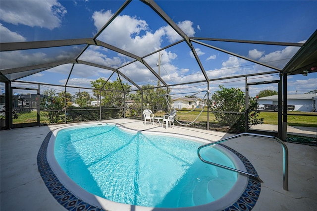 pool featuring a patio area and glass enclosure