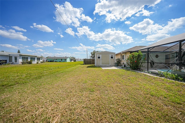 view of yard with glass enclosure and an outdoor structure