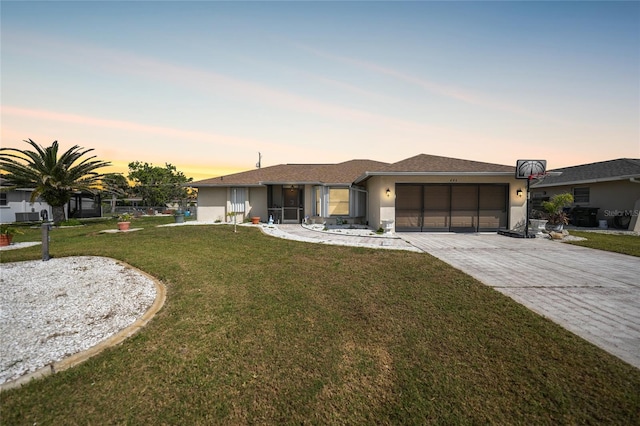 view of front of home featuring a front yard, decorative driveway, an attached garage, and stucco siding