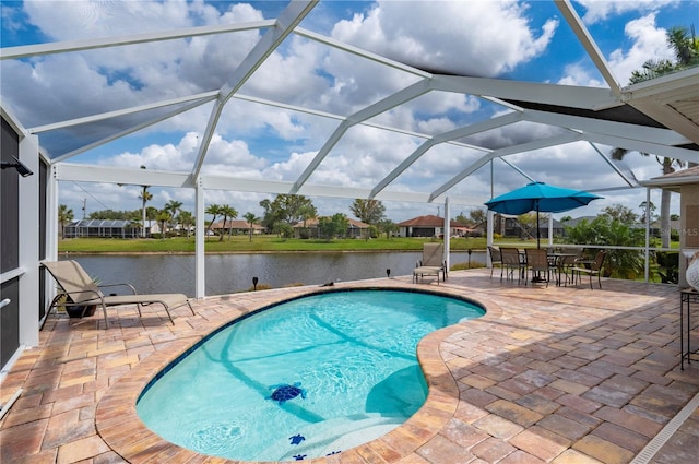 outdoor pool with a patio area, a lanai, and a water view