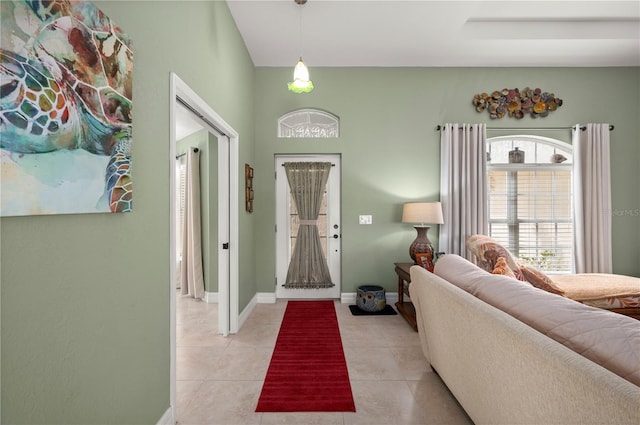 entryway with light tile patterned floors and baseboards