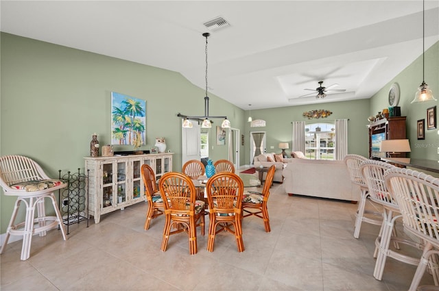 dining room with tile patterned floors, visible vents, ceiling fan, and lofted ceiling