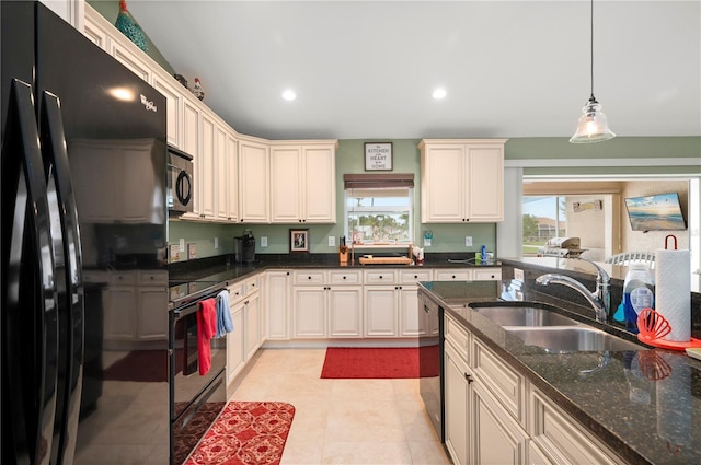 kitchen with dishwasher, pendant lighting, electric range oven, freestanding refrigerator, and a sink