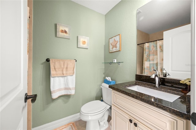 bathroom featuring vanity, a shower with shower curtain, baseboards, tile patterned flooring, and toilet