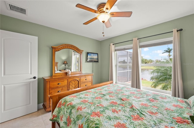 bedroom with light tile patterned flooring, a ceiling fan, and visible vents