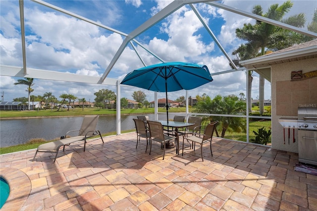 view of patio / terrace featuring a water view, a lanai, and outdoor dining space