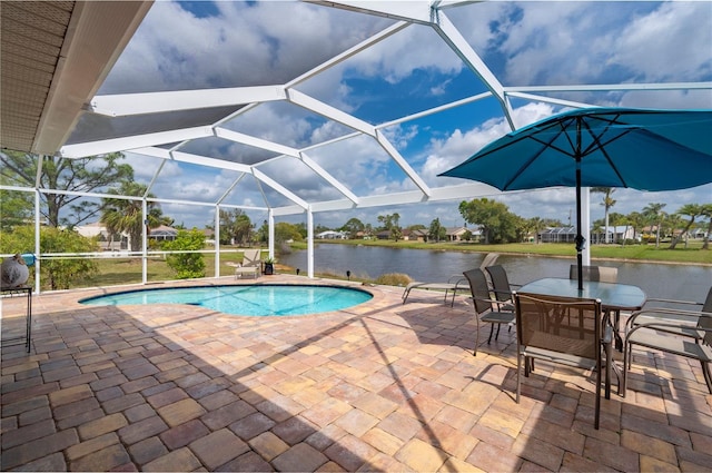 pool with a patio, a lanai, and a water view