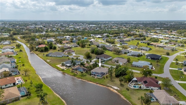 drone / aerial view featuring a residential view and a water view