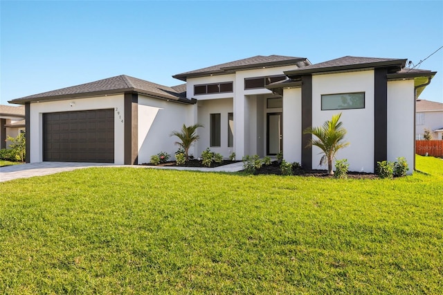 prairie-style house featuring concrete driveway, a front lawn, an attached garage, and stucco siding