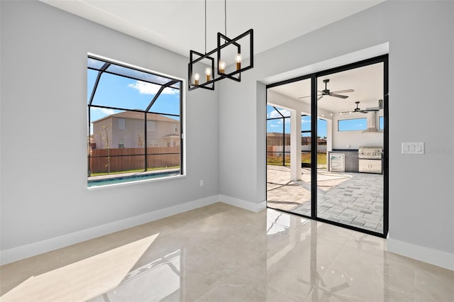 dining space with a sunroom, baseboards, and a wealth of natural light