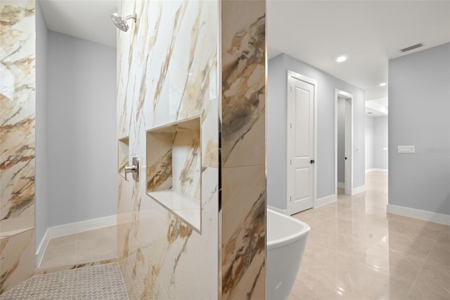 full bathroom featuring a marble finish shower, recessed lighting, visible vents, a freestanding bath, and baseboards