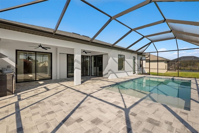 pool featuring a lanai, a patio area, and ceiling fan