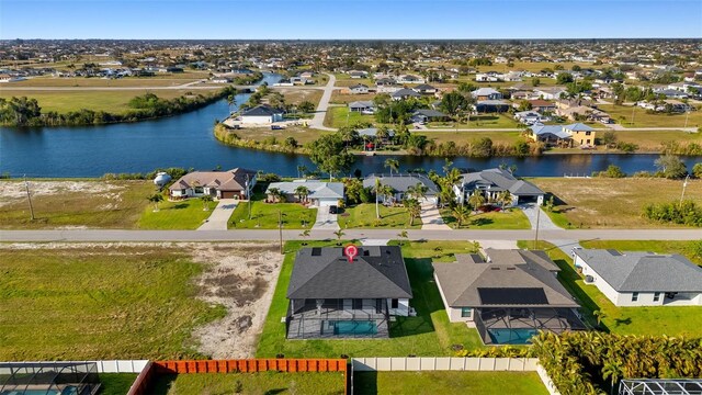 drone / aerial view featuring a water view and a residential view