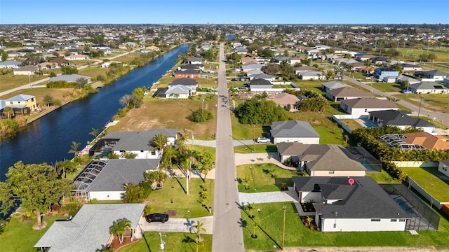 bird's eye view featuring a water view and a residential view