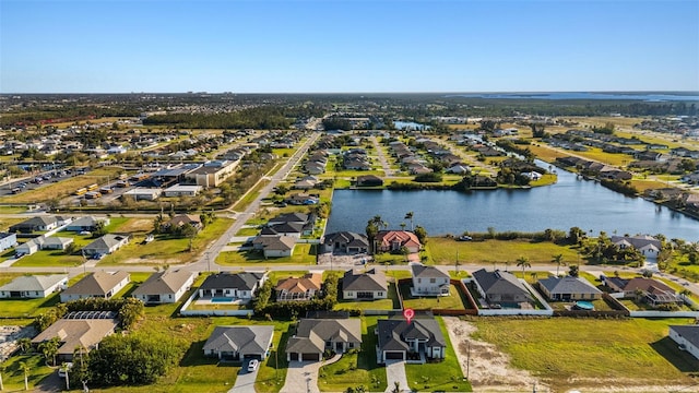 birds eye view of property with a water view and a residential view