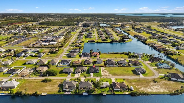 birds eye view of property featuring a water view and a residential view