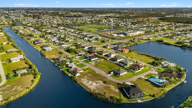 drone / aerial view with a water view and a residential view