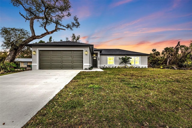 ranch-style house featuring stucco siding, an attached garage, concrete driveway, and a front yard