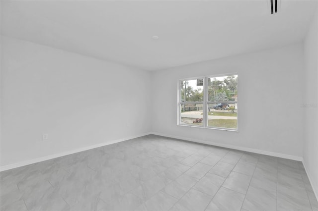 unfurnished room featuring visible vents and baseboards