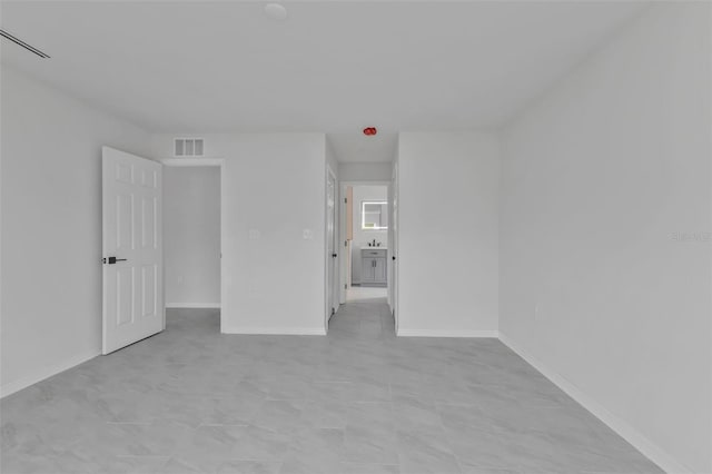 unfurnished bedroom featuring visible vents and baseboards