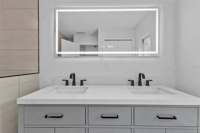 bathroom with a sink, visible vents, and double vanity