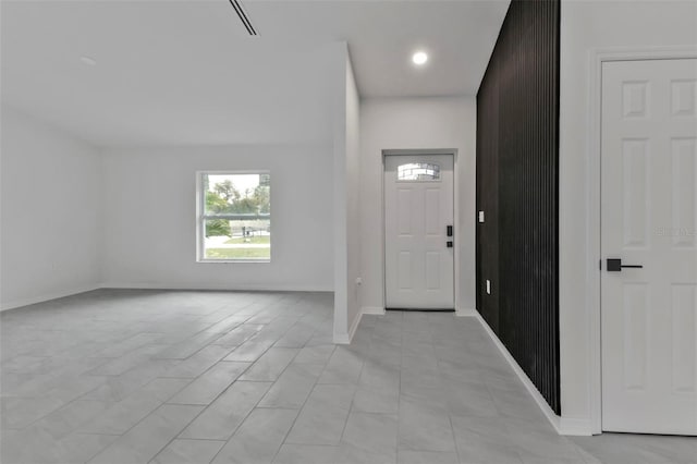 foyer featuring baseboards