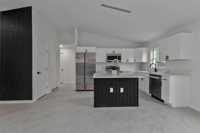 kitchen with light countertops, white cabinets, appliances with stainless steel finishes, and a center island