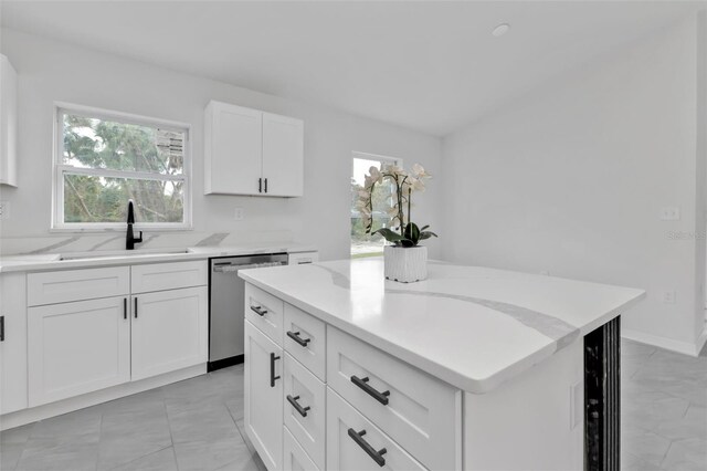 kitchen with a kitchen island, wine cooler, stainless steel dishwasher, white cabinetry, and a sink