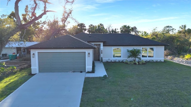 single story home with a garage, stucco siding, driveway, and a front lawn