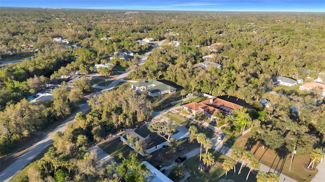 birds eye view of property with a forest view