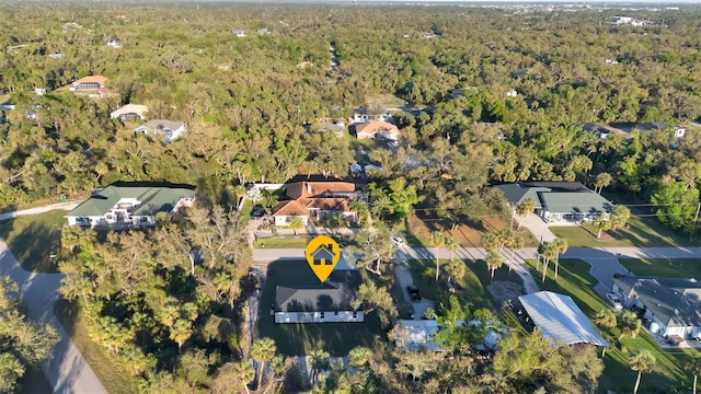 birds eye view of property featuring a wooded view